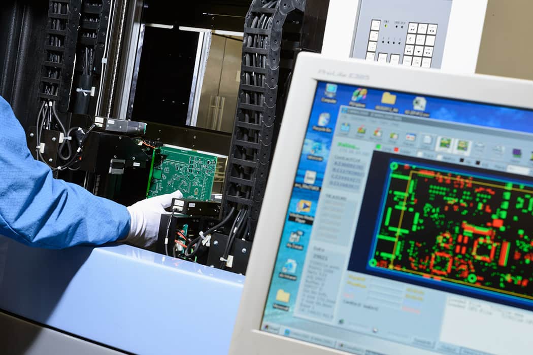 Receive Indianapolis PCB Manufacturing services from DIVSYS image shows technician working on board