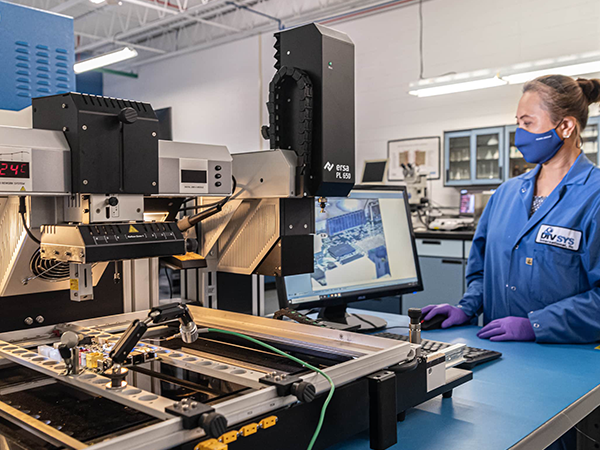 DIVSYS can provide PCBA rework with its Indianapolis PCB Manufacturing image shows technician studying screen