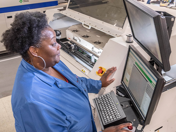 component leads can be soldered with DIVSYS Indianapolis PCB Manufacturing image shows technician looking at screens