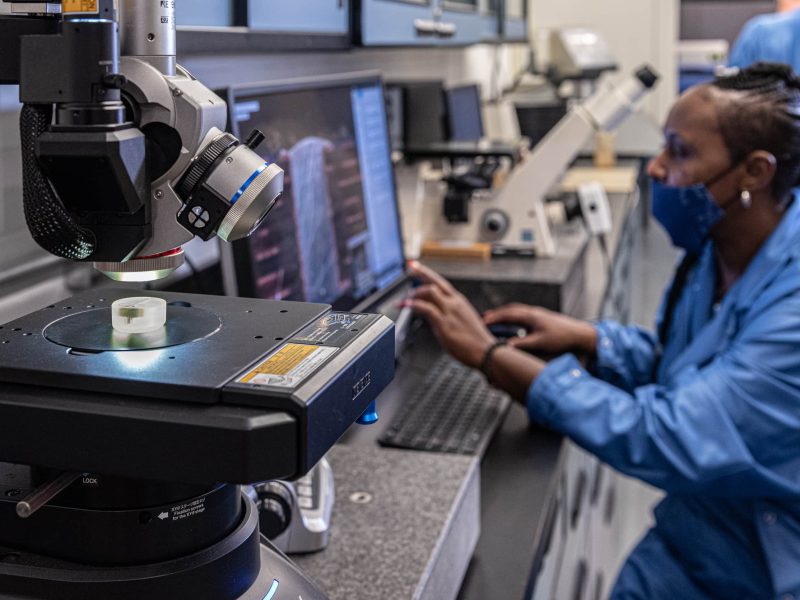 The DIVSYS team can provide microsection analysis for Indianapolis PCBA Manufacturing image shows technician in lab